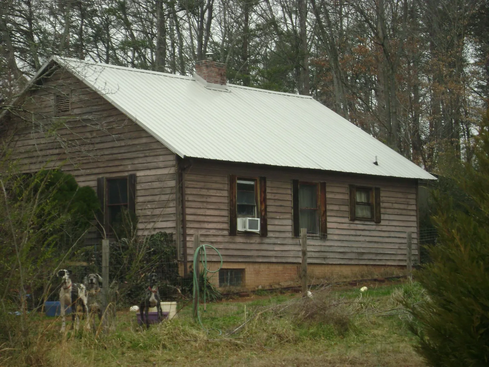 White metal roof on an old wood sided farmhouse, from a Metal Roof Installation job in Epping
